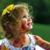 Child engaged in art therapy session painting at a table in a therapy room