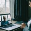 Woman at home on a laptop for an online therapy session for adults with autism.