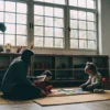 Child in an autism therapy session with a parent, learning effective social communication skills.