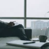 Man on a couch showing signs and symptoms of PTSD after a traumatic experience.
