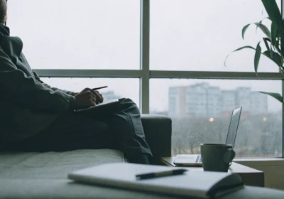 Man on a couch showing signs and symptoms of PTSD after a traumatic experience.