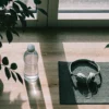 Yoga mat and headphones for healthy ways to cope with stress and prevent emotional exhaustion.