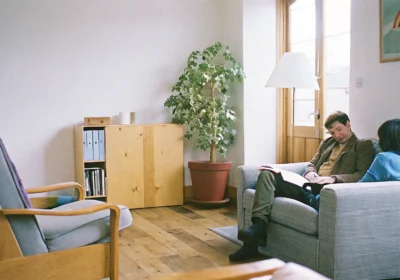 Two people in an LGBTQ-affirming therapy session discussing family rejection and relationship challenges.