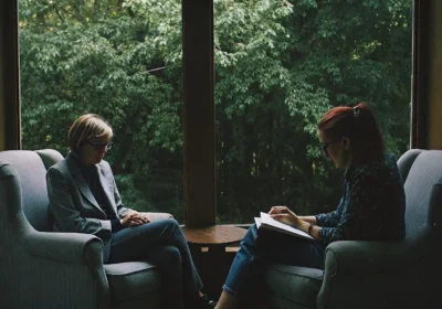 Two people in an LGBTQ affirming therapy session discussing identity and self-acceptance.