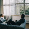 A couple on a couch talking together to heal from emotional disconnection in their partnership.
